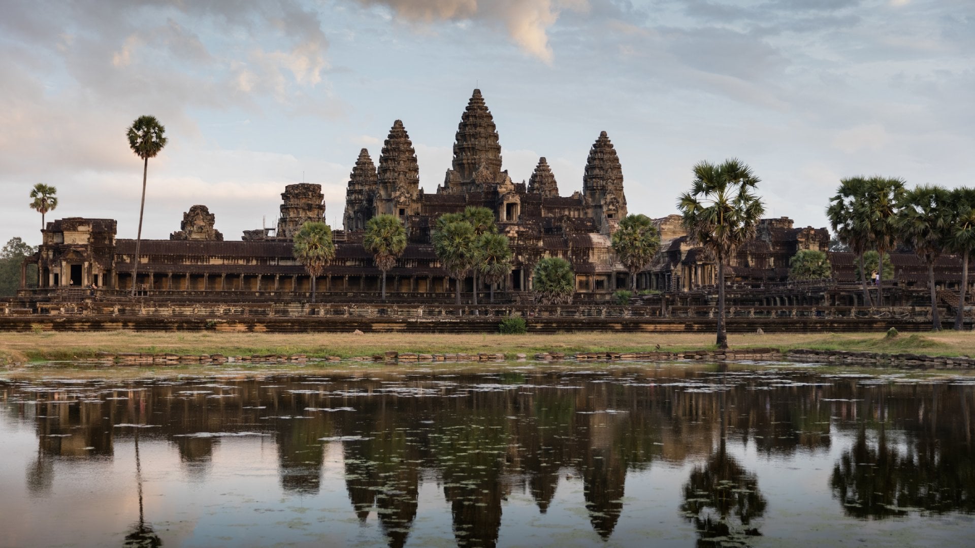 Monumental Angkor Wat Temple in early morning light after sunrise under beautiful cloudy sky. Angkor Wat, Siem Reap, Cambodia